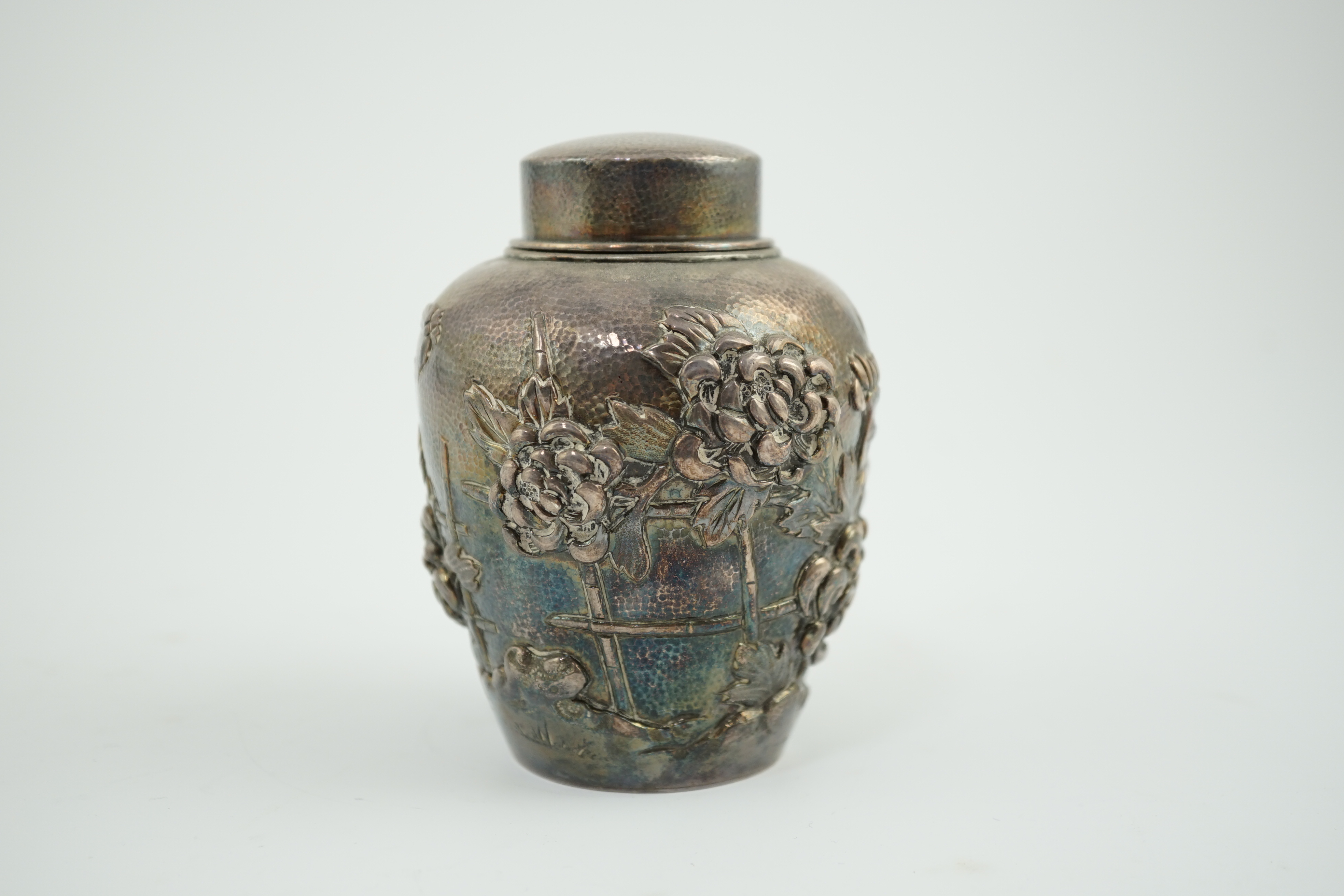 An early 20th century Japanese silver ovoid tea caddy and cover, decorated with prunus, together with a similar Japanese silver bowl